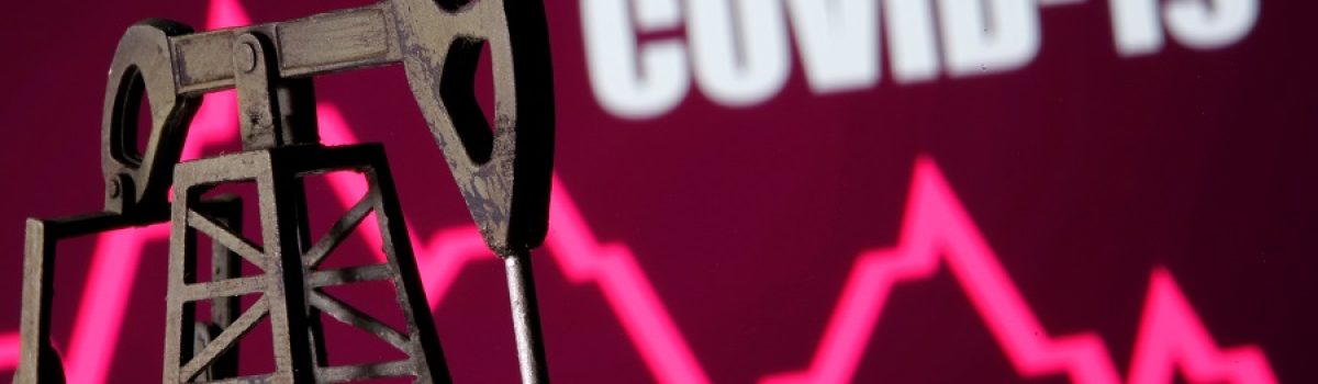 A 3D printed oil pump jack is seen in front of displayed stock graph and "Covid-19" words in this illustration picture, April 14, 2020. REUTERS/Dado Ruvic/Illustration