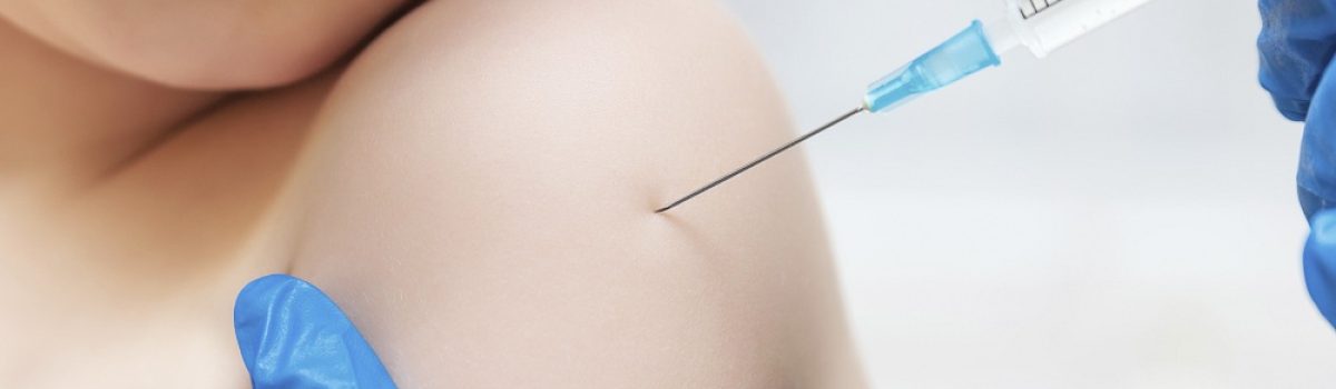 Boy and vaccine syringe
